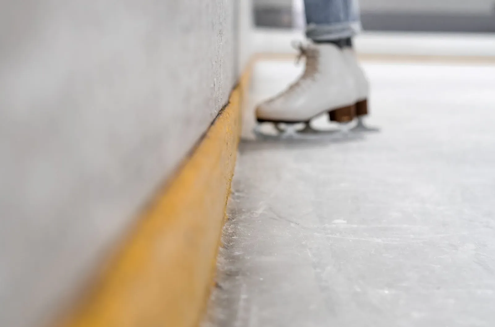 Close-up photo of ice skates on an ice rink