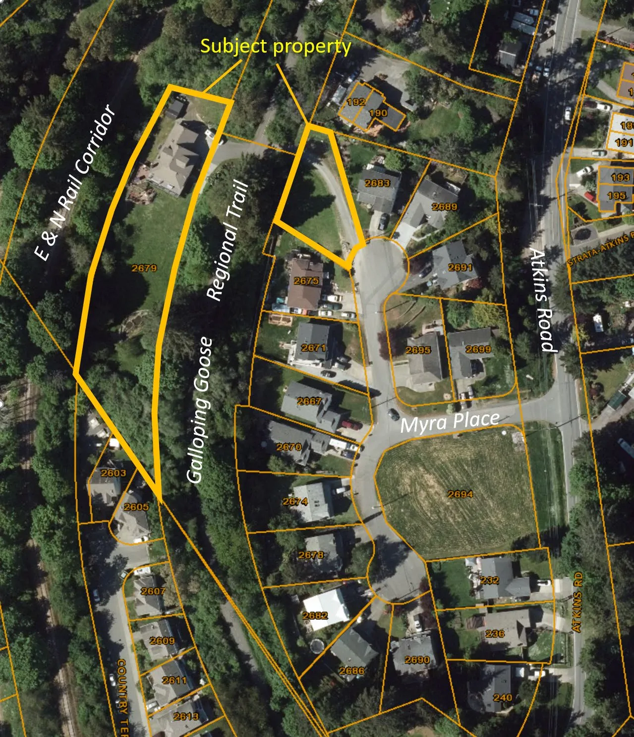 Aerial photo showing the subject property at 221 Atkins Road, highlighting its location relative to the E & N Rail Corridor, Galloping Goose Regional Trail, Myra Place, and Atkins Road.