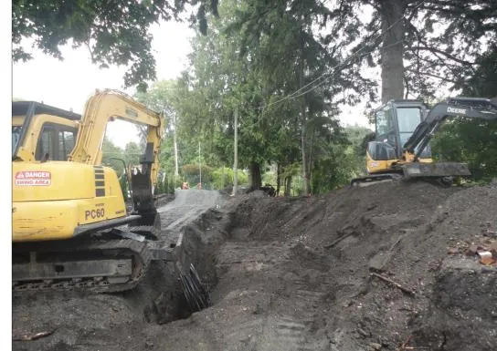Excavator operating in an area previously excavated for a project