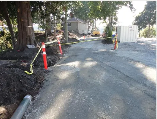 Overview of the construction site with yellow caution tape and a storage container