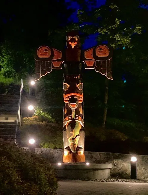 Illuminated totem pole at the Public Safety Building at night