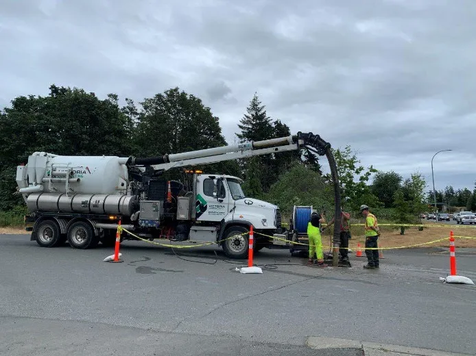 Construction crew and vacuum truck performing sinkhole assessment