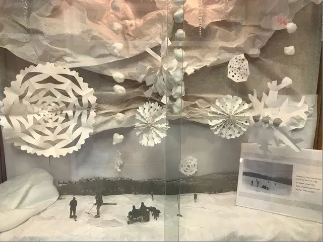 Archives foyer display featuring a 3-D portrayal of a 1969 scene of people skating on Esquimalt Harbour