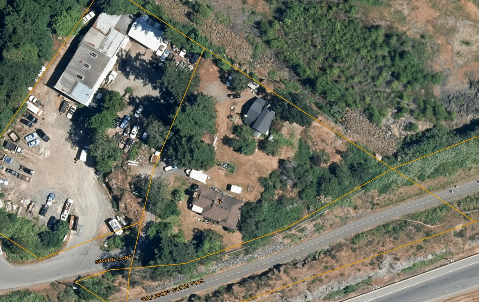Aerial map of 5 Erskine Lane showing property boundaries, buildings, and numbered tree locations, with labels for Erskine Lane and the Galloping Goose Trail.