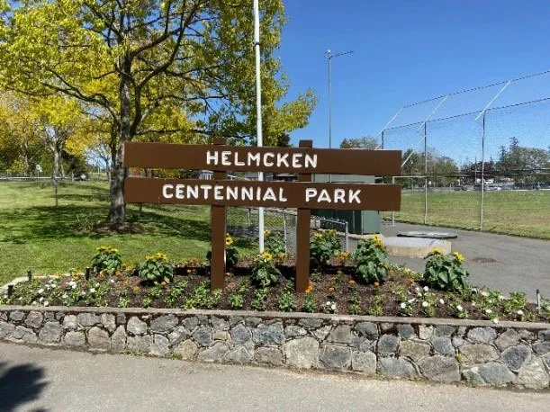 Flower beds at the entrance sign for Helmcken Centennial Park