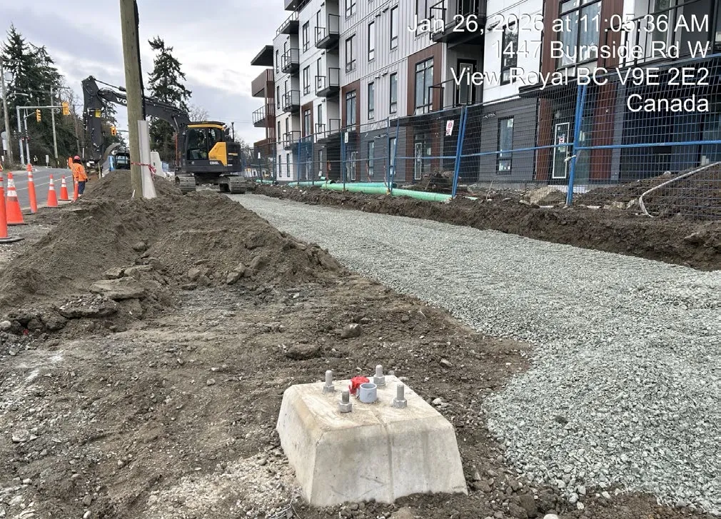Machinery performing rock shearing at 3 Helmcken Road construction site