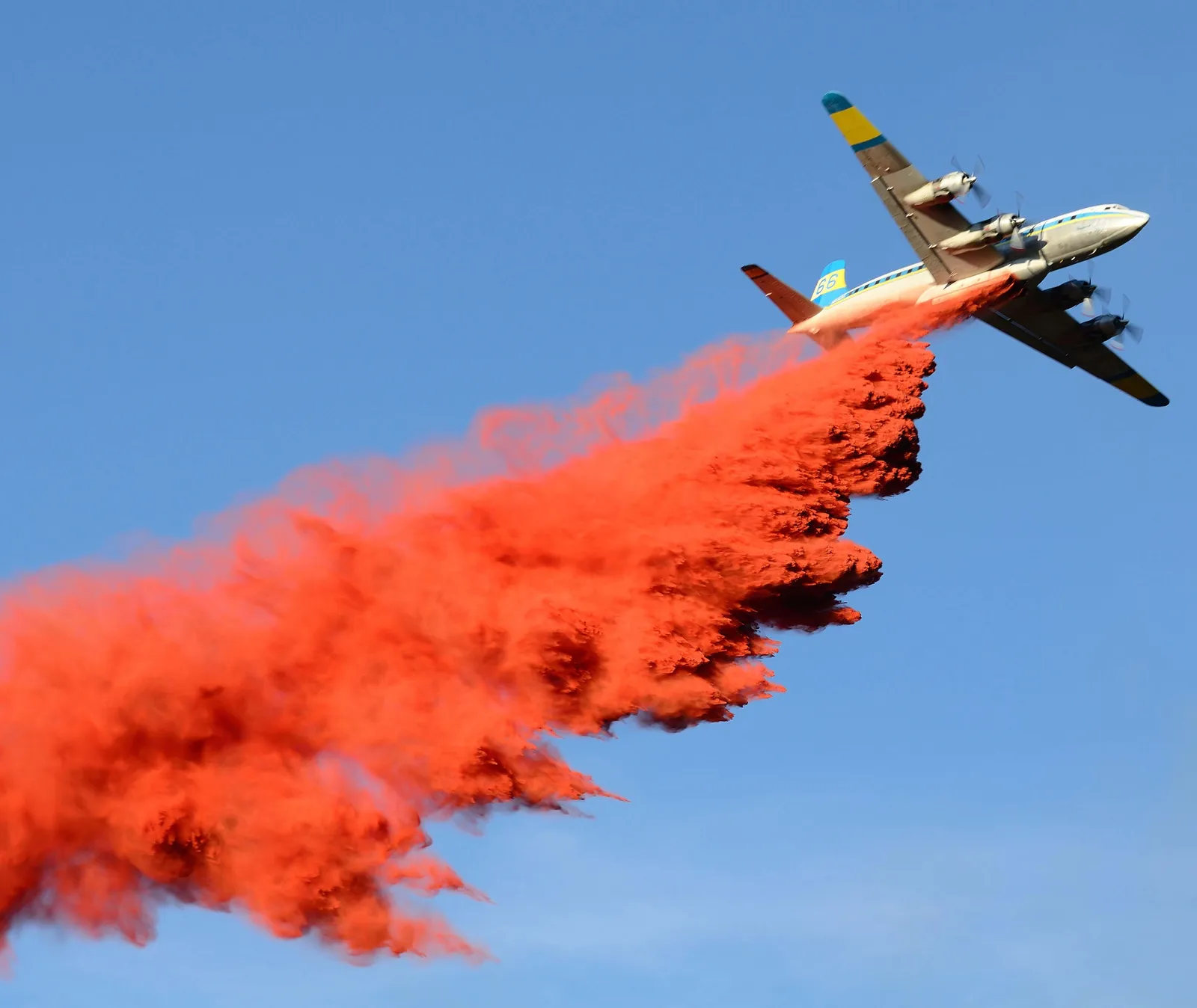 Air tanker dropping red fire retardant on the Mill Hill Fire