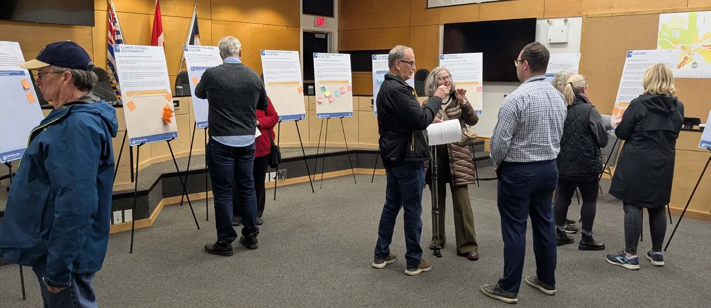 Members of the community and Town staff reviewing information boards at a public engagement event