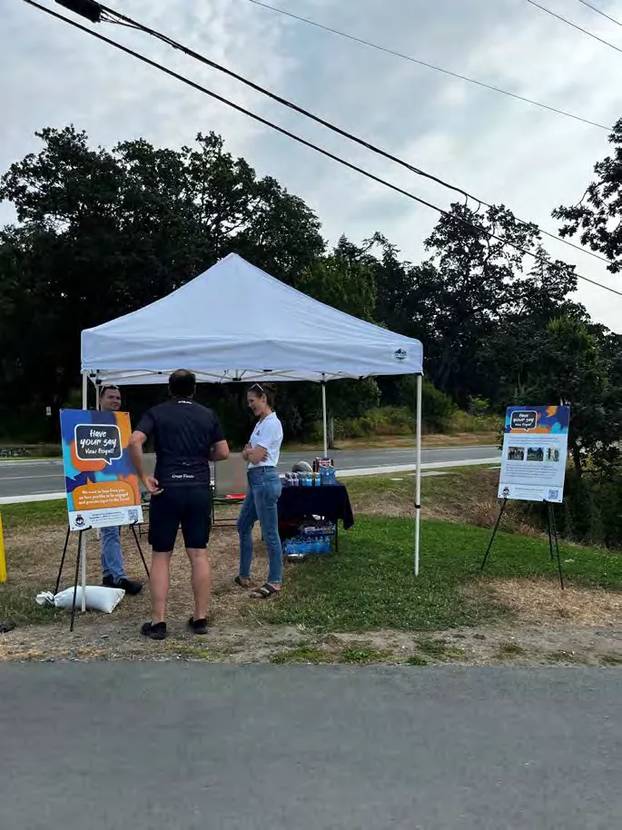 Engagement staff standing at a pop-up booth at an outdoor event