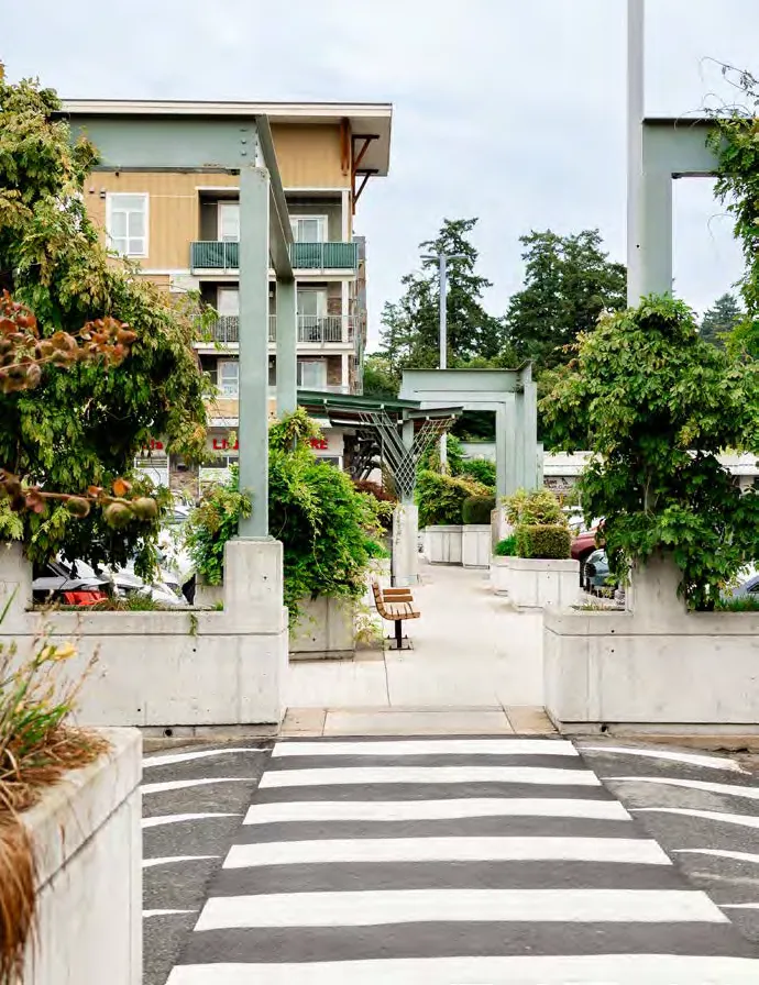 Tree-lined residential street with parked cars and sidewalks