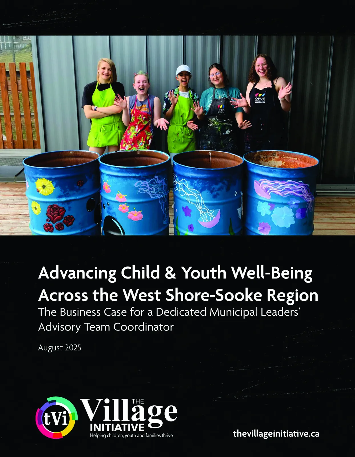 Five youth wearing aprons stand behind four blue metal barrels painted with floral and jellyfish designs