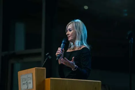 Woman speaking at a podium