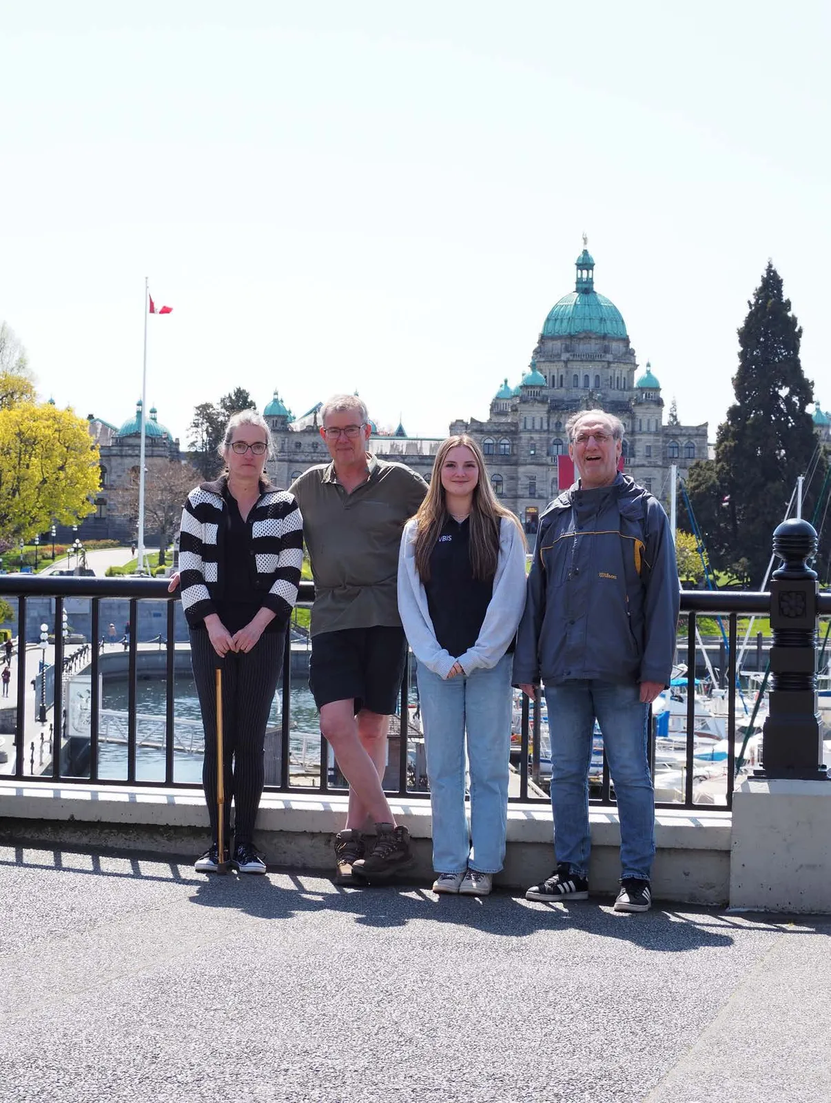 Group of four people standing in front of the BC Parliament Buildings
