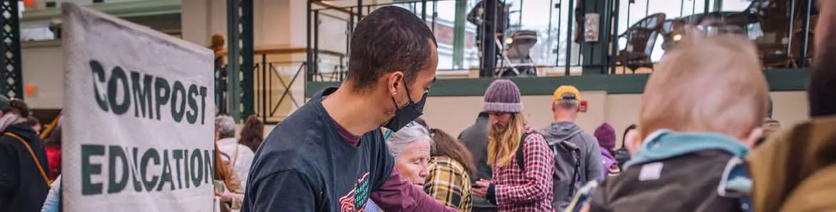 People gathered at a Compost Education Centre outreach table