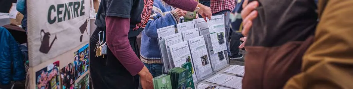 Detail of informational pamphlets and sign-up sheets at an outreach event
