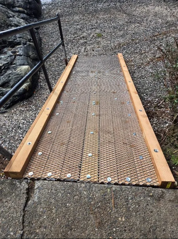 New metal mesh anti-slip decking installed on a wooden ramp