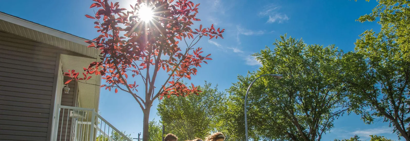 Photo of children running and playing soccer in a residential yard