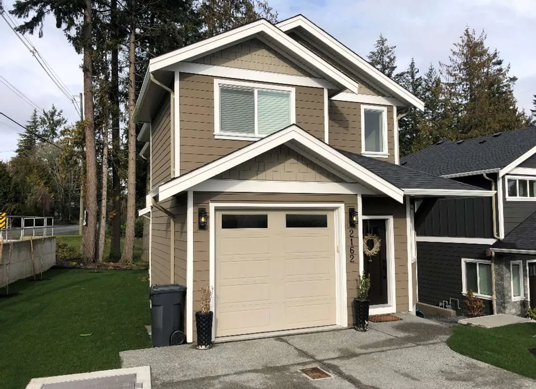 Photo of a completed blue and grey townhouse building