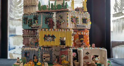 A highly detailed, multi-level gingerbread house with candy decorations