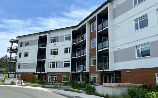 Multi-story residential building with balconies.