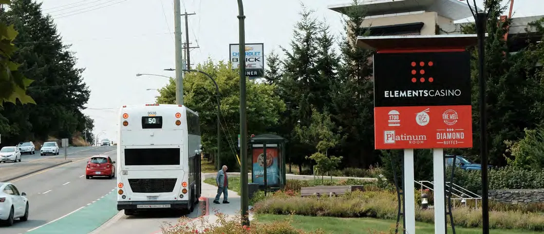 Sign for Elements Casino with a bus in the foreground.