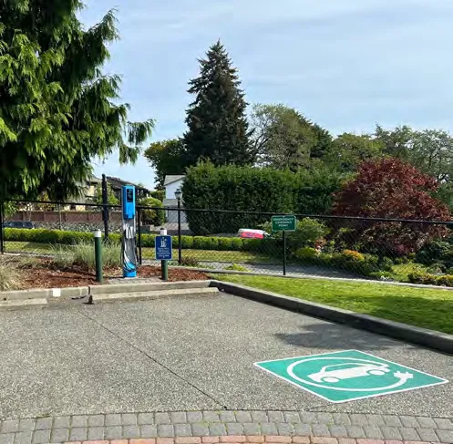 Electric vehicle charging station in a parking lot.