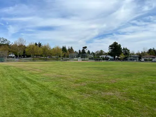 A baseball field with a fence.