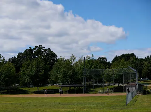 A large grassy field in a park.