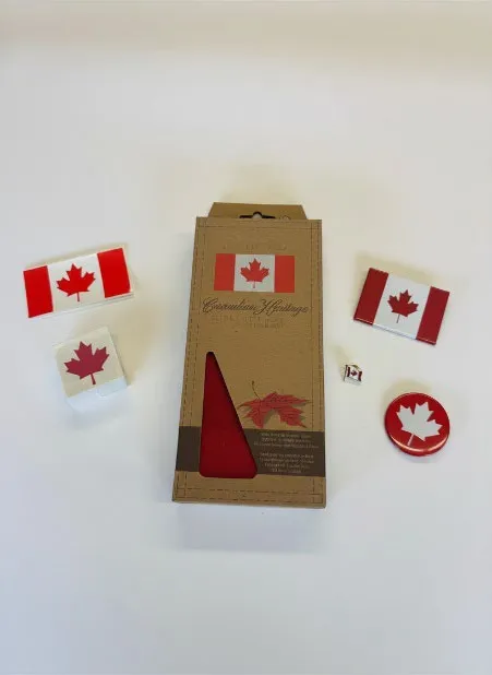 Canada Day promotional giveaway items in a branded box including a maple leaf sticker and pins