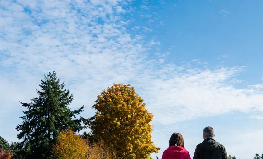 Two people walking on the E&N Rail Trail Overpass