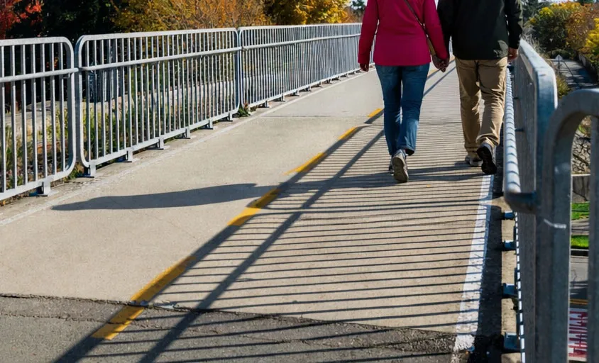Close-up of pedestrians' feet on the overpass path
