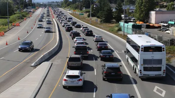 Aerial view of a bus-only lane on a highway with adjacent heavy traffic congestion