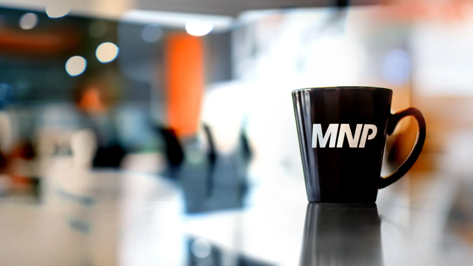 MNP coffee mug on a table in an office setting