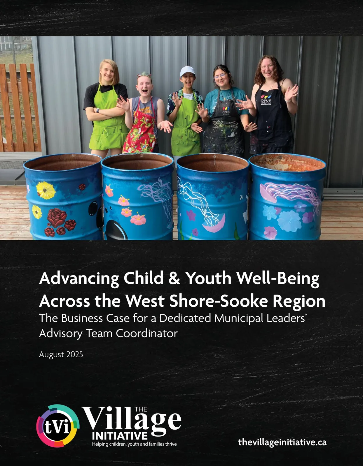 Five youth standing behind four painted blue metal barrels.