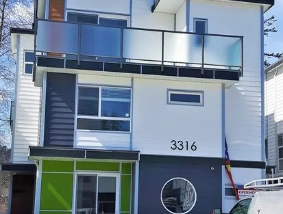 Photograph of the exterior of a modern residential building at address 3316