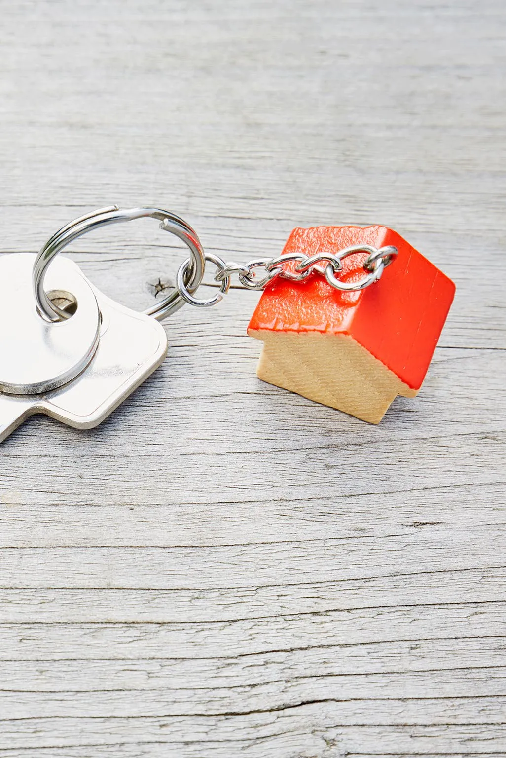 Photo of house keys with a small wooden house-shaped keychain