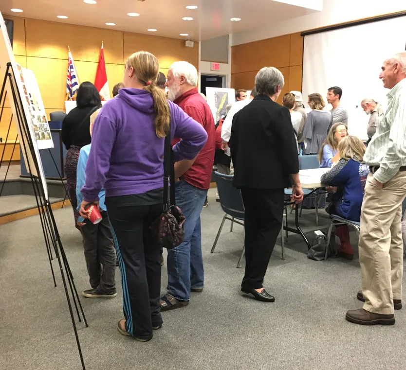 People in a room looking at boards