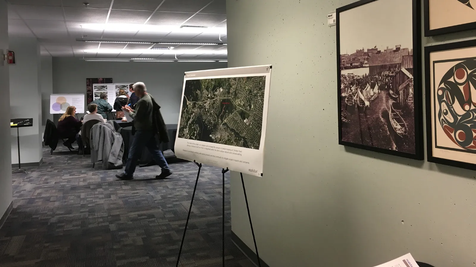Person walking in an office with displays