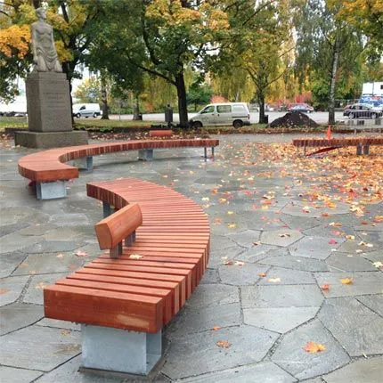 Curved wooden slatted bench in an urban plaza
