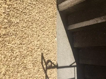 Exterior - SE lower side by stairs - Textured Stucco