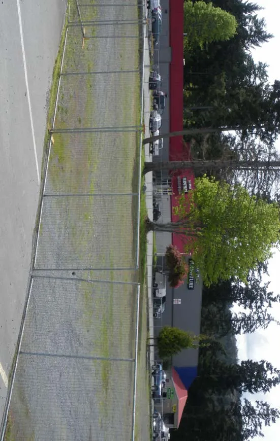Contextual Street View #3 - View of side of building with chain link fence