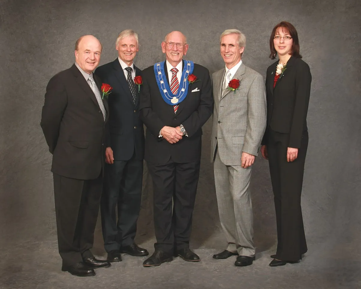 Headshot of Councillor Ron Mattson in a suit with a red rose boutonniere.