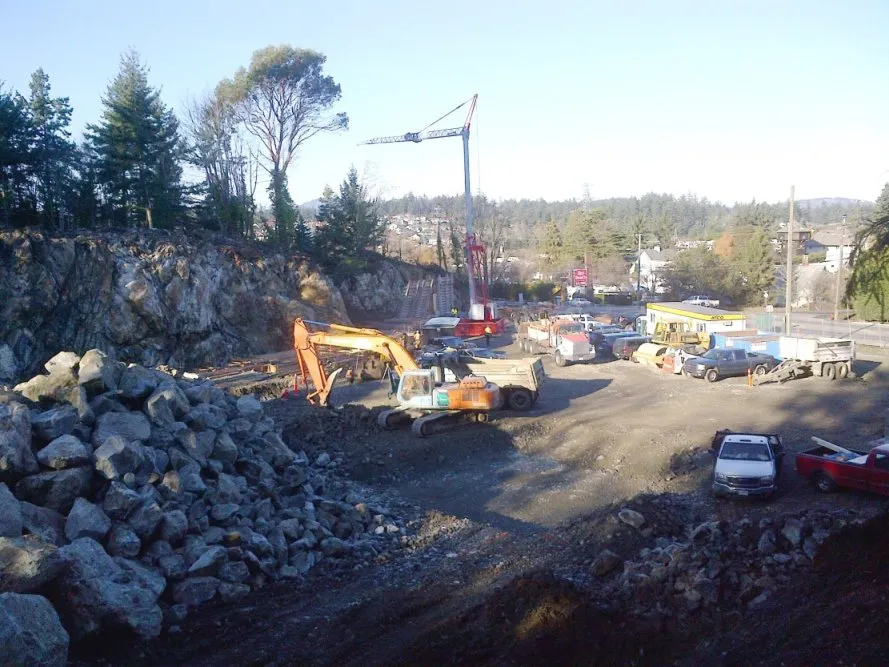 Construction site with heavy machinery and piles of rock for the new Public Safety Building.