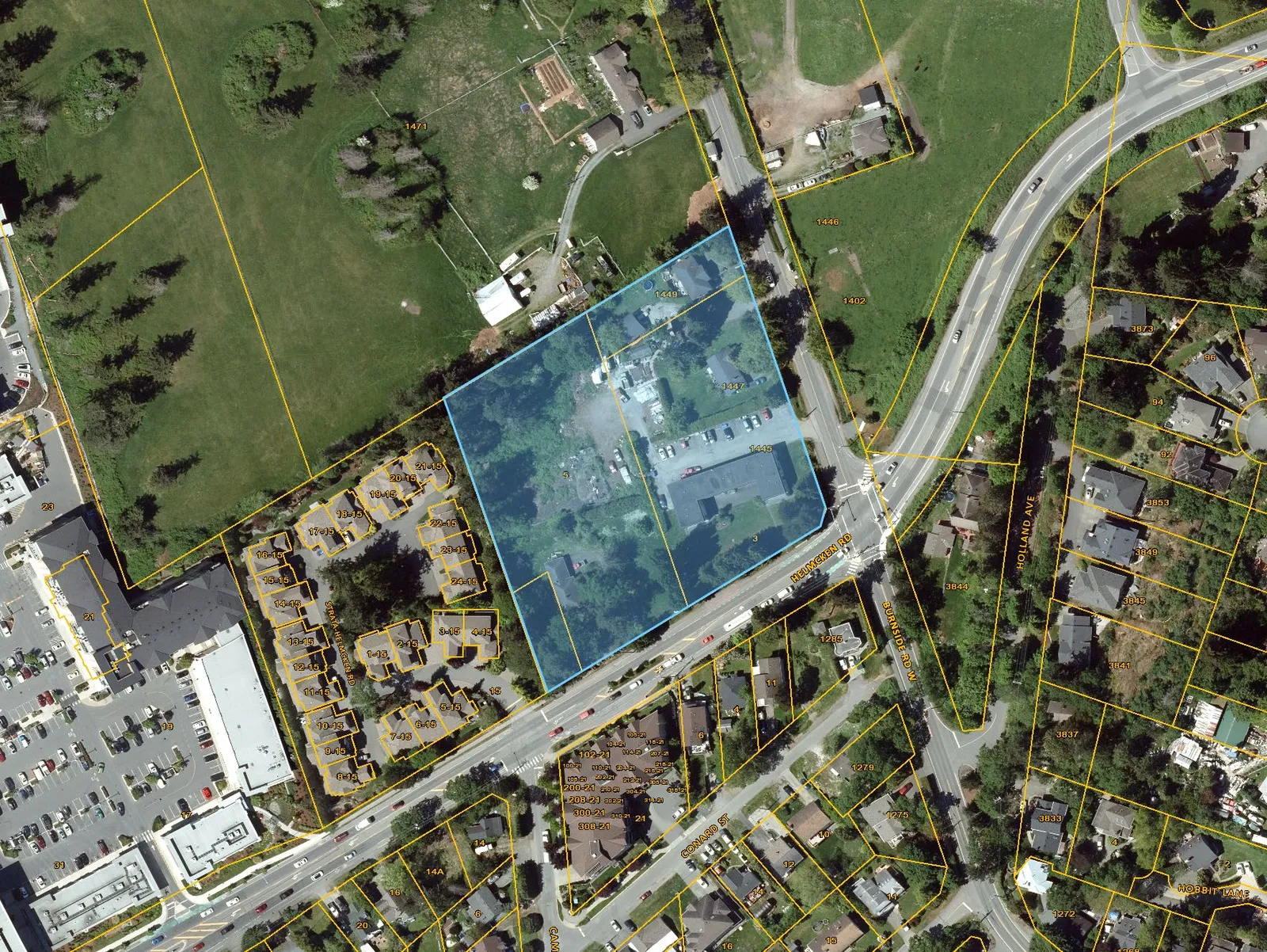 Aerial map showing the four parcels highlighted in blue at the corner of Helmcken Road and Burnside Road