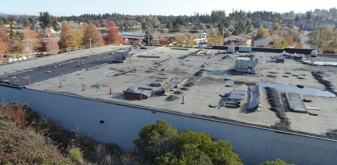 Wide photograph showing the extensive flat rooftop and mechanical equipment of the existing Canadian Tire store