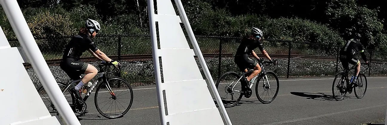 Group of cyclists riding on a paved trail