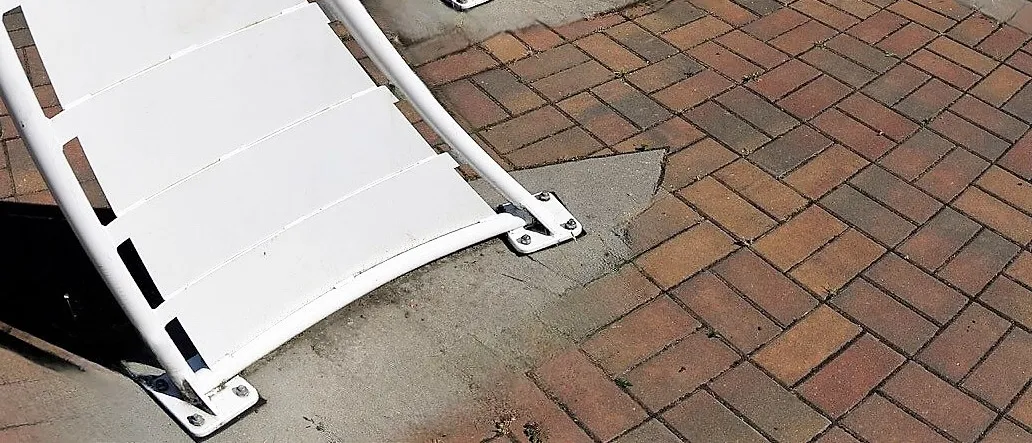 Close-up of brick pavement and the base of a structure