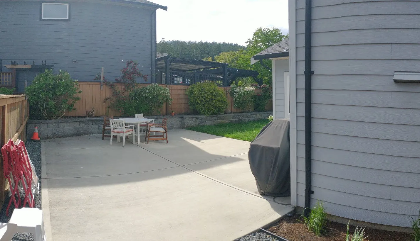 Photograph of the existing concrete patio area behind the house