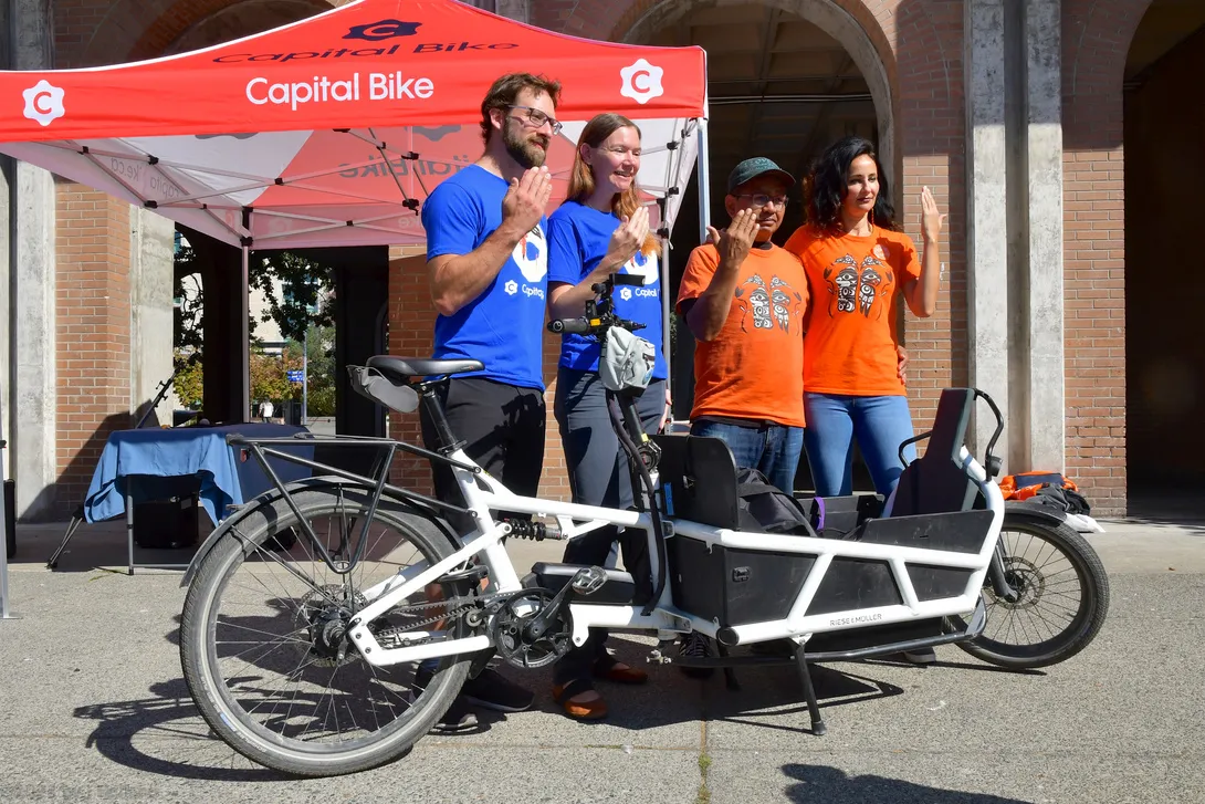 Back of a blue GoByBike BC t-shirt showing sponsor logos