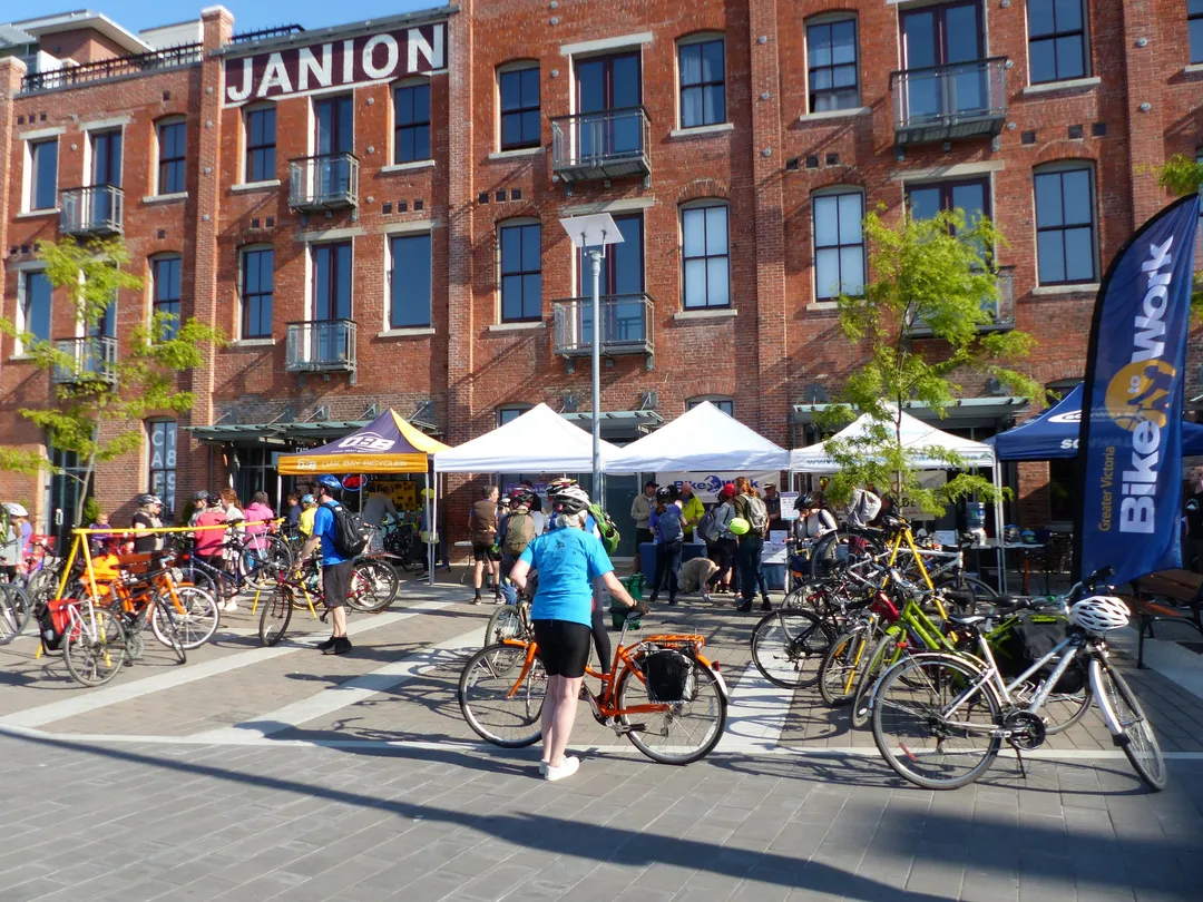 A speaker being filmed under a red Capital Bike tent